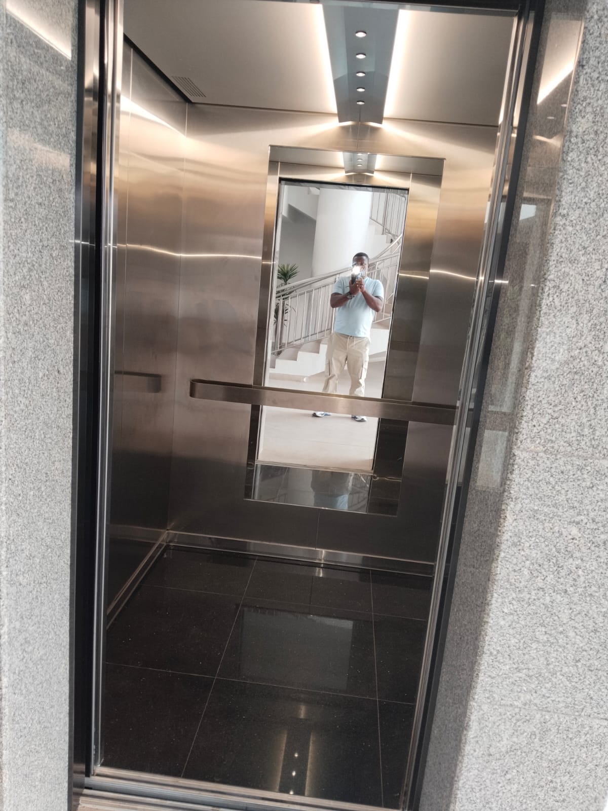 Passenger lift cabin interior with stainless steel finishes