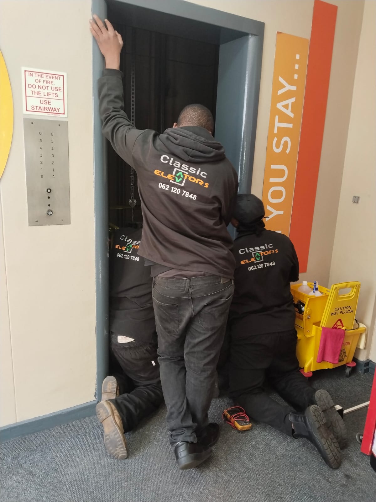 Classic Elevators technicians working at a lift entrance